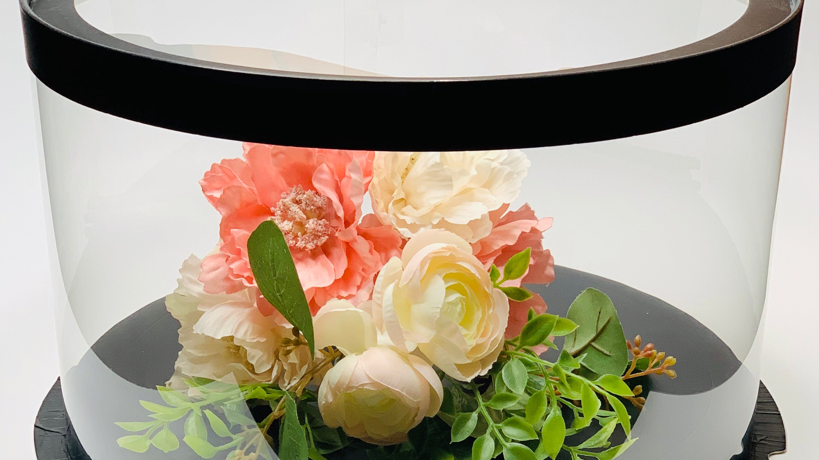 flowers in clear short round cake box