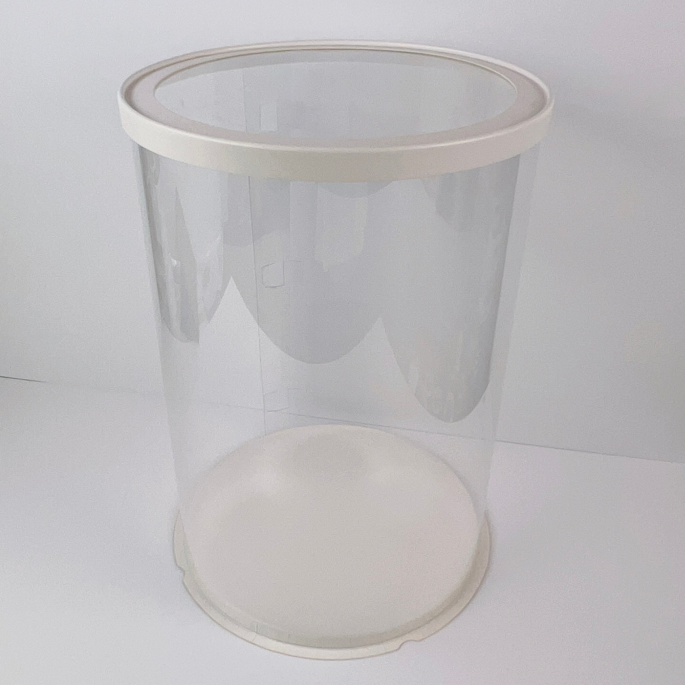 Clear plastic container with a white lid on a white background