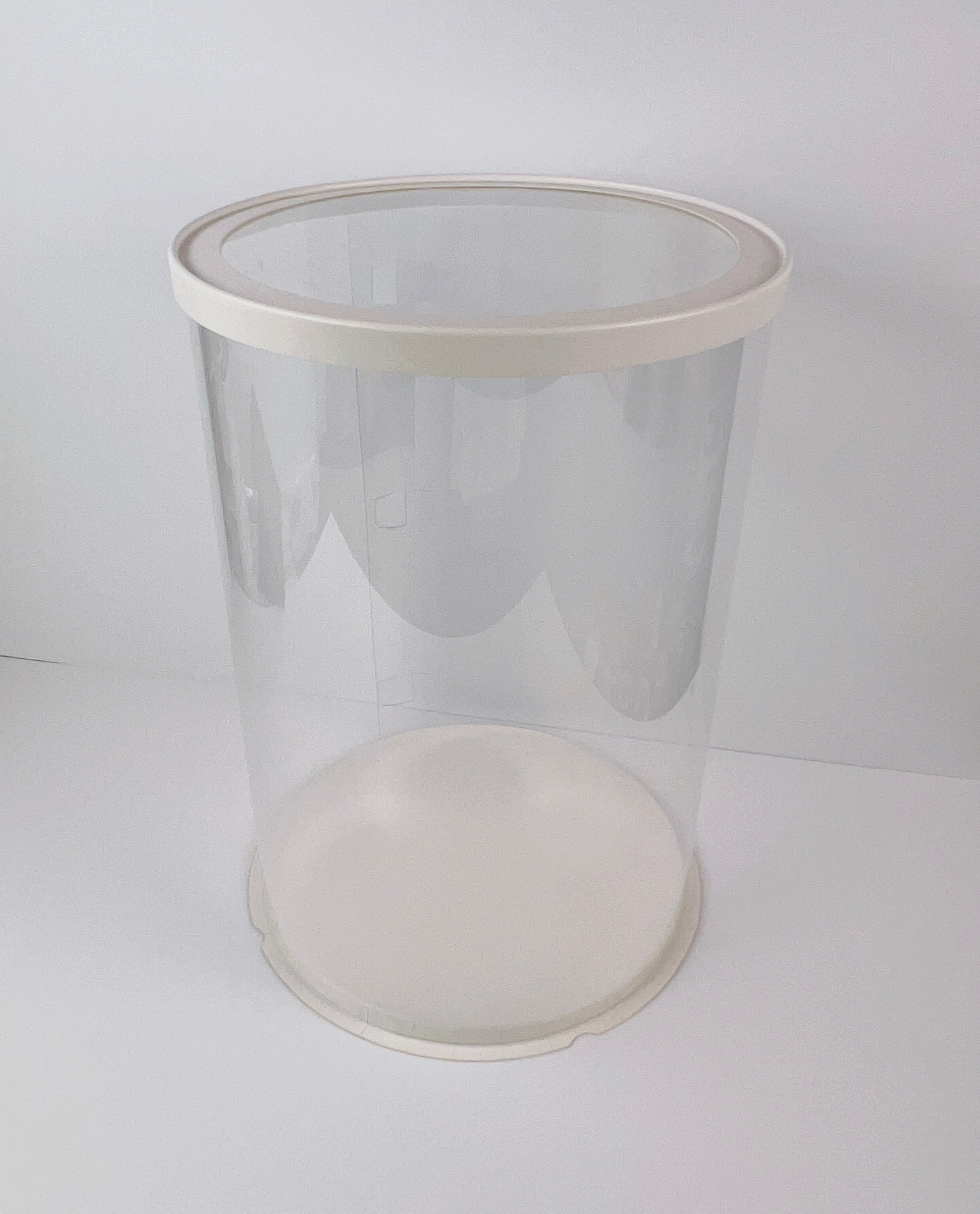 Clear plastic container with a white lid on a white background