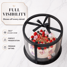 Clear round cake display box with black lid, base, and ribbon, showing a decorated birthday cake with full 360 degree visibility.